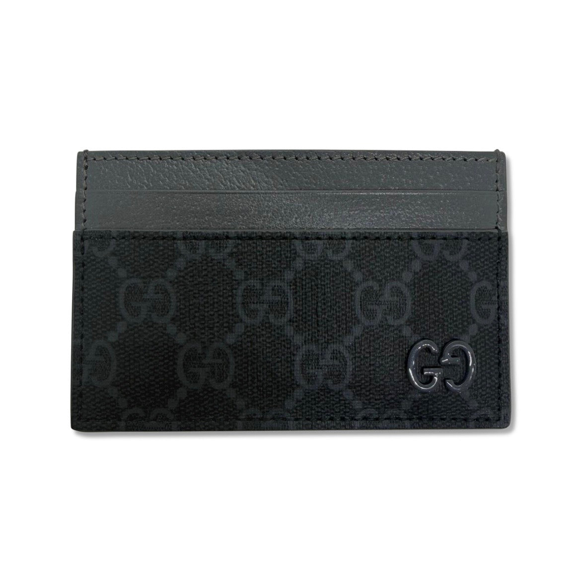 A black leather and canvas card holder with an embossed GG monogram pattern and a silver-tone interlocking G logo, shown on a plain white background.